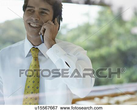 Stock Photo - Young businessman on phone. Fotosearch
