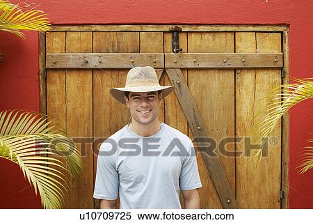 Young man by wooden window shutters View Large Photo Image Stock Photography - Young man by wooden window shutters. Fotosearch