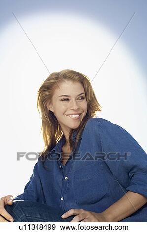 Young woman against sky (portrait) View Large Photo Image Stock Photo - Young woman against sky (portrait). Fotosearch