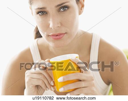 Stock Image - Young woman holding mug. Fotosearch