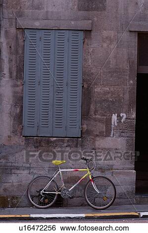 Stock Photograph - Bicycle Leaning Against Wall. Fotosearch