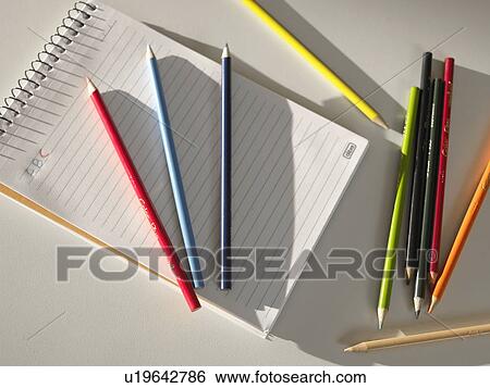 Stock Photograph - Colored pencils on notepad (directly above). Fotosearch