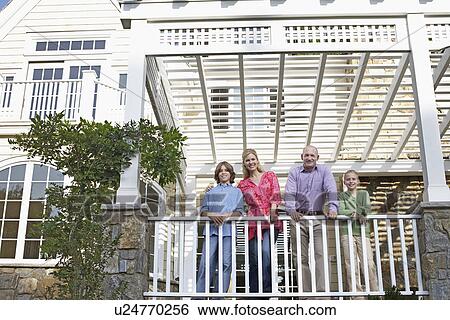 Stock Photograph - Family of four on balcony. Fotosearch