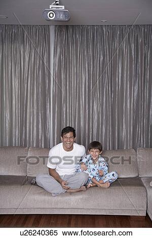 Father and son watching TV View Large Photo Image Stock Photography - Father and son watching TV. Fotosearch