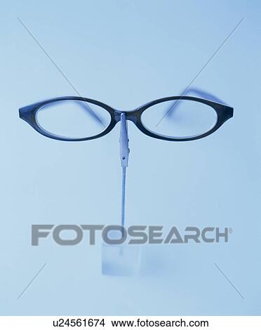 Picture - Glasses Held By Crocodile Clip. Fotosearch