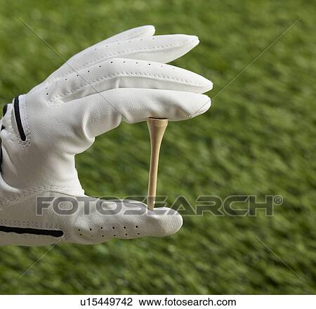 Stock Image - Human Hand Holding Golf Tee. Fotosearch