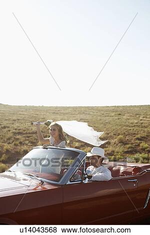 Newlyweds driving convertible through desert, Arizona, USA View Large Photo Image Stock Photo - Newlyweds driving convertible through desert, Arizona, USA. Fotosearch