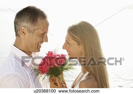 Stock Image - Newlyweds on beach. Fotosearch