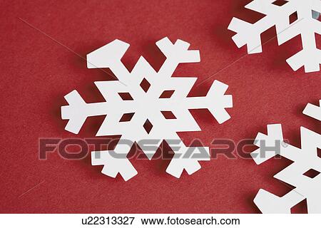 Paper snowflakes on red background (close-up) View Large Photo Image Stock Photo - Paper snowflakes on red background (close-up). Fotosearch
