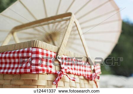 Picnic basket near parasol View Large Photo Image Stock Photo - Picnic basket near parasol. Fotosearch