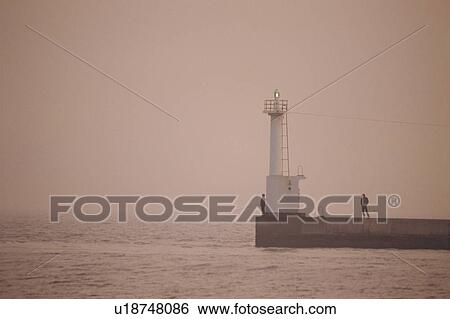 The Lighthouse In Twilight, And An Angler'S Shadow View Large Photo Image Stock Photograph - The Lighthouse In Twilight, And An Angler'S Shadow. Fotosearch