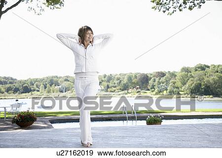 Stock Photo - Woman stretching near pool. Fotosearch