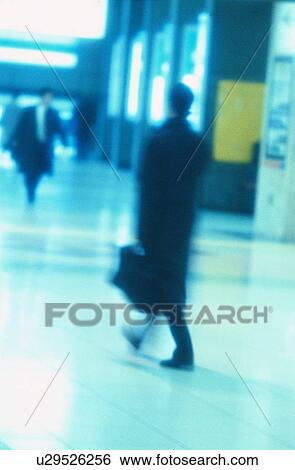 Stock Photograph - Businessmen In Train Station. Fotosearch