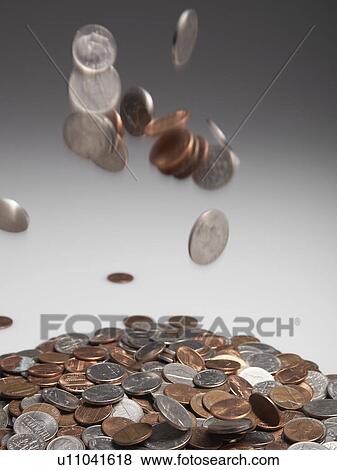 Stock Photo - Coins Falling on Pile. Fotosearch