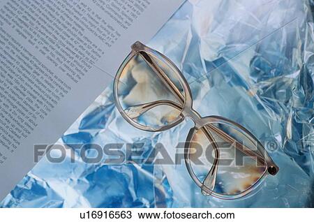 Stock Image - Eyeglasses Near Book Page. Fotosearch