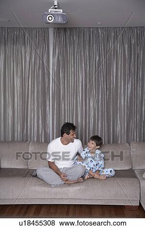Stock Photo - Father and son watching TV. Fotosearch