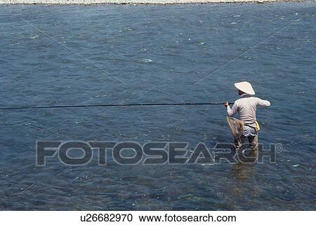 Stock Image - Fisher In Water. Fotosearch