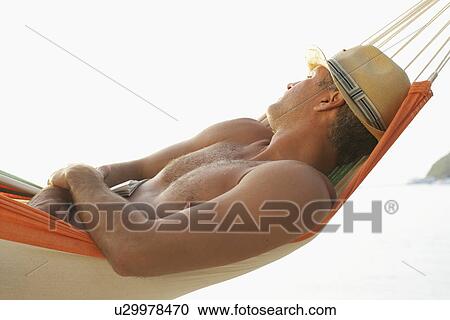 Mid adult man sleeping in hammock View Large Photo Image Stock Image - Mid adult man sleeping in hammock. Fotosearch