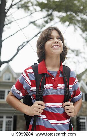 Portrait of schoolboy (12-13) looking up View Large Photo Image Picture - Portrait of schoolboy (12-13) looking up. Fotosearch