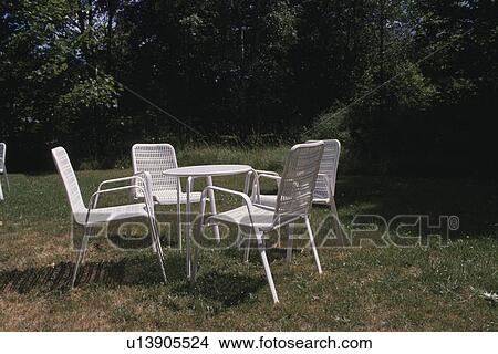 The White Chair And Table In A Garden View Large Photo Image Picture - The White Chair And Table In A Garden. Fotosearch