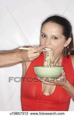 Woman eating noodles View Large Photo Image Stock Image - Woman eating noodles. Fotosearch