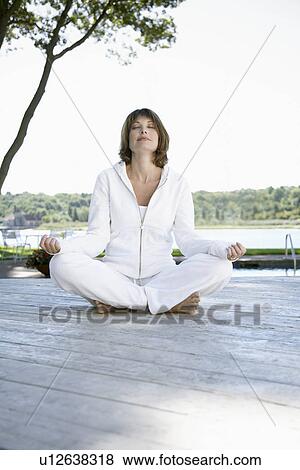 Woman meditating on deck View Large Photo Image Stock Photo - Woman meditating on deck. Fotosearch