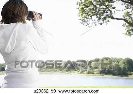 Woman using binoculars View Large Photo Image Stock Photo - Woman using binoculars. Fotosearch