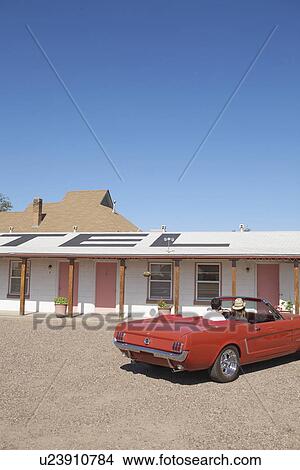 Young couple in convertible at motel, Arizona, USA View Large Photo Image Picture - Young couple in convertible at motel, Arizona, USA. Fotosearch