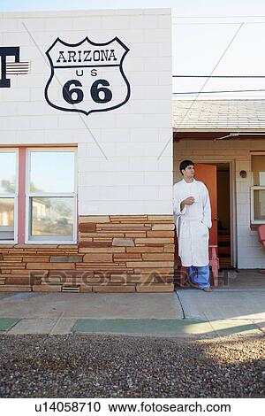 Young man drinking coffee at motel in morning, Arizona, USA View Large Photo Image Stock Image - Young man drinking coffee at motel in morning, Arizona, USA. Fotosearch