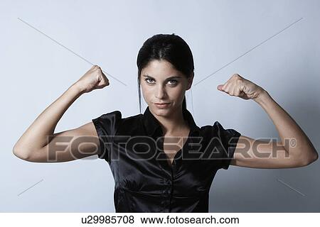 Stock Photo - Young woman flexing muscles. Fotosearch