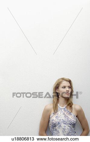 Young woman leaning on wall (portrait) View Large Photo Image Stock Image - Young woman leaning on wall (portrait). Fotosearch