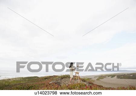 Young woman painting on beach View Large Photo Image Stock Photo - Young woman painting on beach. Fotosearch