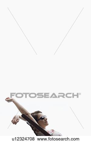 Young woman stretching on lounge chair View Large Photo Image Stock Photo - Young woman stretching on lounge chair. Fotosearch