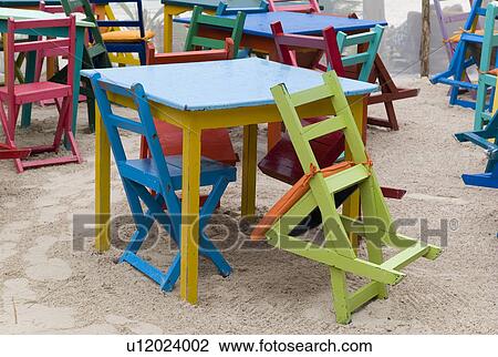 Stock Image - Colourful tables and chairs in Tulum Mexico. Fotosearch