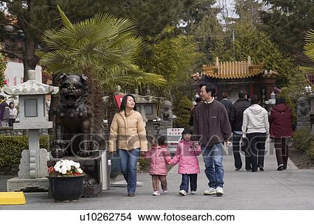 Family walking down the street View Large Photo Image Picture - Family walking down the street. Fotosearch