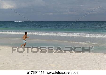 Man jogging on beach in Tulum Mexico View Large Photo Image Stock Image - Man jogging on beach in Tulum Mexico. Fotosearch
