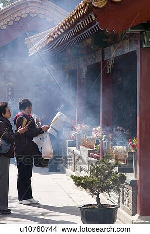 Picture - People burning inscents. Fotosearch