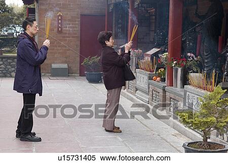 Stock Photography - People lighting inscents. Fotosearch