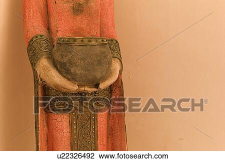 Stock Image - Statue holding a container. Fotosearch