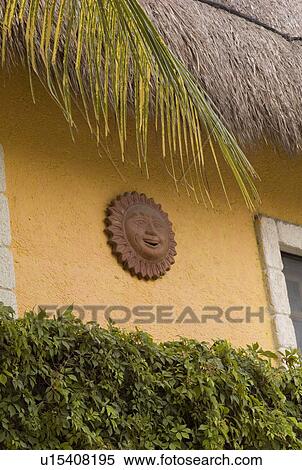 Stock Photography - Sun symbol on exterior of building in Tulum Mexico. Fotosearch