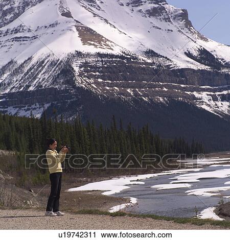 Tourist taking a picture of landscape View Large Photo Image Stock Image - Tourist taking a picture of landscape. Fotosearch