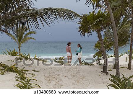 Stock Image - Tourists on the beach in Tulum Mexico. Fotosearch