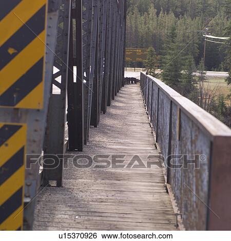 Stock Photograph - Walkway on side of bridge. Fotosearch