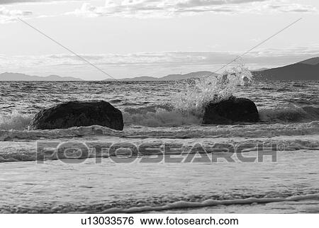 Stock Photograph - Water crashing into rocks. Fotosearch