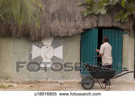 Stock Photography - Wheelbarrel in front of a Mexican hut. Fotosearch