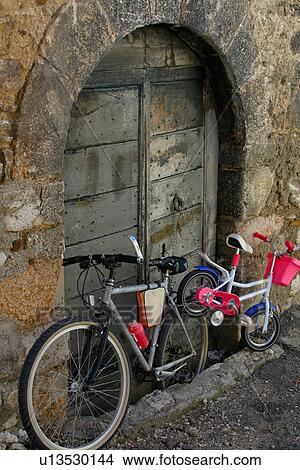adult and child's bicycles outside medieval arched doorway in Norcia, Umbria View Large Photo Image Picture - adult and child's bicycles outside medieval arched doorway in Norcia, Umbria. Fotosearch
