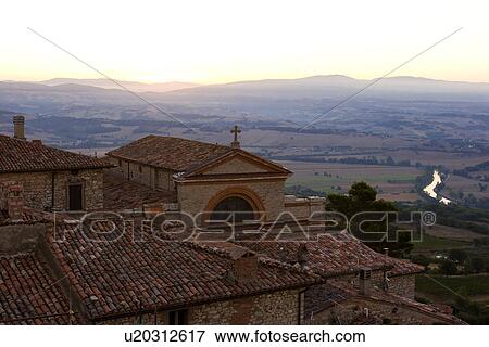 Stock Photo - Aerial landscape view of Montecastello di Vibio, showing River Tiber, roof tops, church San Filippo e Giacomo at sunrise. Fotosearch