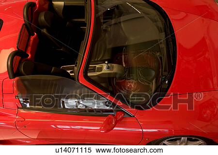 Aerial view from side, of red Ferrari sports car convertible, front detail showing seats and dash board View Large Photo Image Stock Photography - Aerial view from side, of red Ferrari sports car convertible, front detail showing seats and dash board. Fotosearch