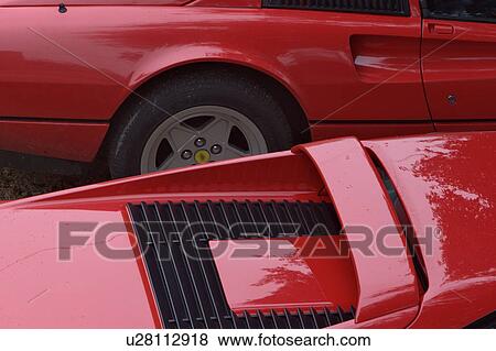 Stock Photo - Aerial view of 2 parked red Ferraris,, on cloudy rainy day. Fotosearch