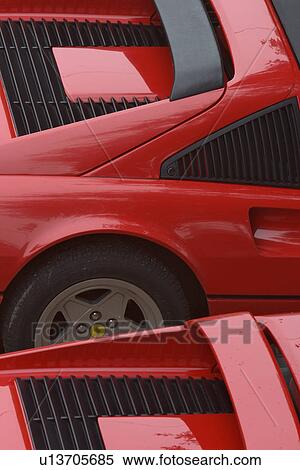 Stock Photography - Aerial view of 2 parked red Ferraris,, on cloudy rainy day. Fotosearch